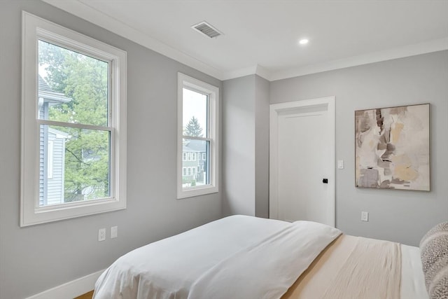 bedroom with multiple windows, crown molding, baseboards, and recessed lighting