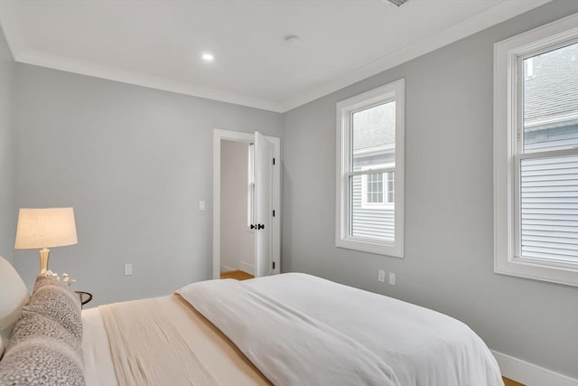 bedroom with crown molding, baseboards, and recessed lighting