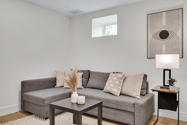 living area featuring light wood-type flooring and baseboards