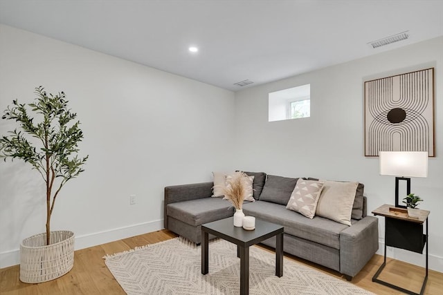 living room with light wood-style flooring, baseboards, and recessed lighting