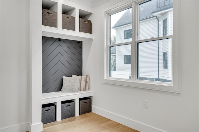 mudroom with baseboards and light wood-style flooring