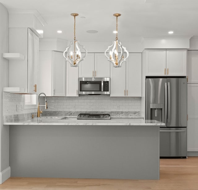 kitchen with light hardwood / wood-style floors, white cabinetry, stainless steel appliances, and sink