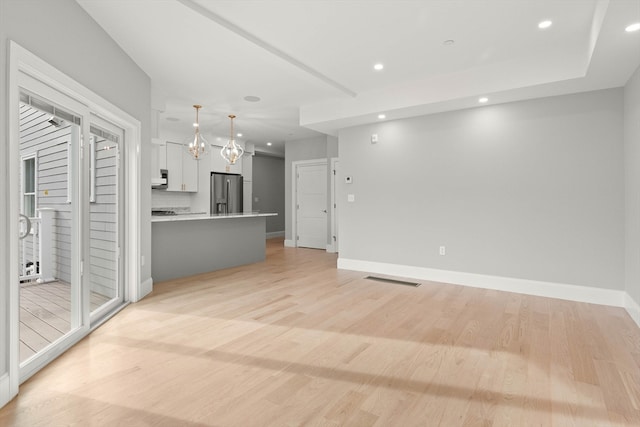 unfurnished living room with light wood-type flooring