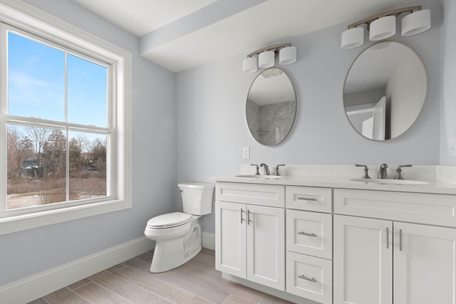 bathroom featuring vanity, hardwood / wood-style floors, and toilet