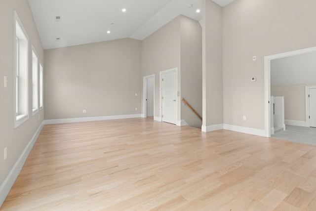 unfurnished living room featuring light hardwood / wood-style floors and high vaulted ceiling