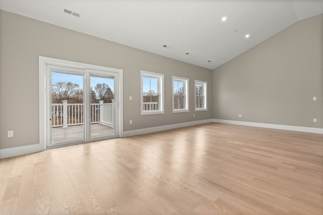 unfurnished living room featuring light hardwood / wood-style flooring and lofted ceiling