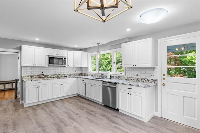 190 Winthrop St, Taunton, MA 02780 - kitchen with stainless steel appliances, tasteful backsplash, light wood-style flooring, white cabinets, and recessed lighting