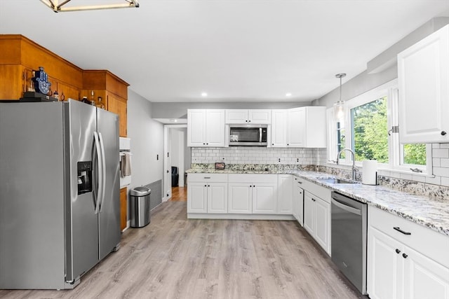 190 Winthrop St, Taunton, MA 02780 - kitchen with appliances with stainless steel finishes, backsplash, light wood-type flooring, white cabinets, and recessed lighting