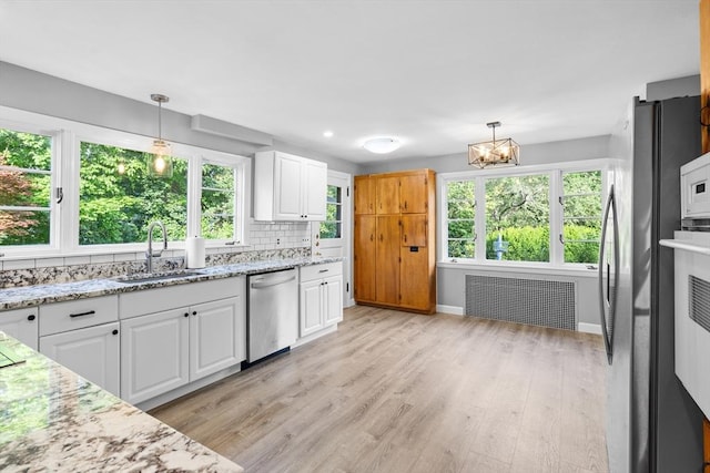 190 Winthrop St, Taunton, MA 02780 - kitchen with dishwasher, radiator, white cabinets, and plenty of natural light