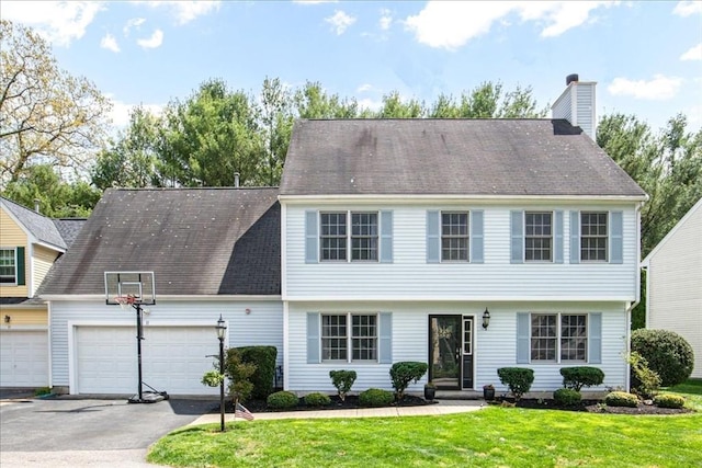11 Crane Rd Unit 11, Walpole, MA 02081 - colonial-style house with an attached garage, a front lawn, asphalt driveway, and a chimney