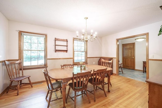 9 Lauren Ln, Southwick, MA 01077 - dining space with light wood-type flooring, a chandelier, and baseboards