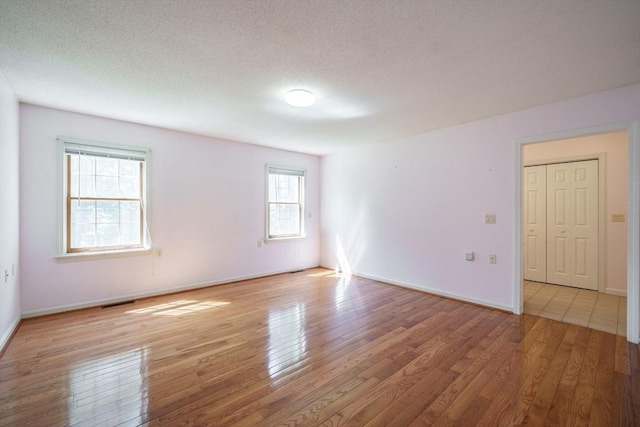 9 Lauren Ln, Southwick, MA 01077 - empty room with wood finished floors, baseboards, and a textured ceiling