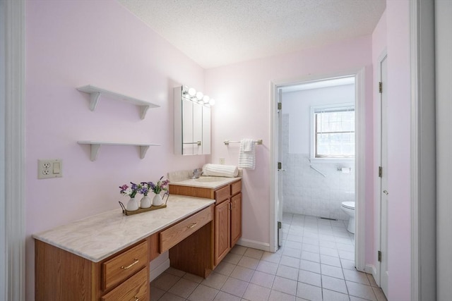9 Lauren Ln, Southwick, MA 01077 - full bath featuring tile patterned flooring, toilet, vanity, and a textured ceiling