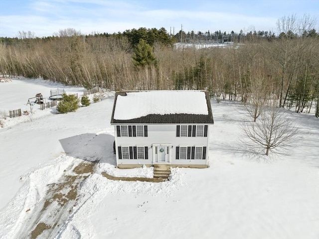 view of snow covered rear of property