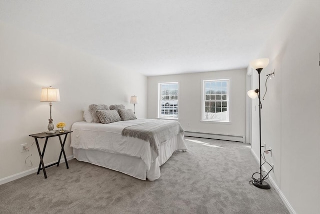 bedroom with light carpet, baseboards, and a baseboard heating unit