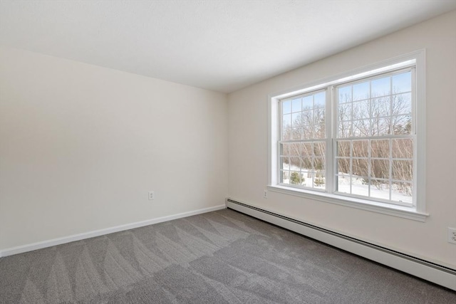 unfurnished room with a baseboard heating unit, carpet, and baseboards