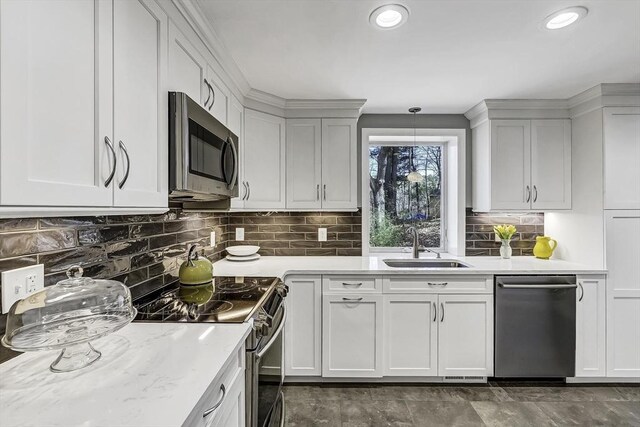 35 Wallace Rd, Wayland, MA 01778 - kitchen featuring white cabinets, a sink, appliances with stainless steel finishes, backsplash, and hanging light fixtures