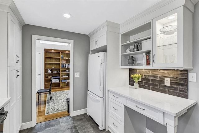 35 Wallace Rd, Wayland, MA 01778 - kitchen featuring freestanding refrigerator, white cabinets, baseboards, and tasteful backsplash