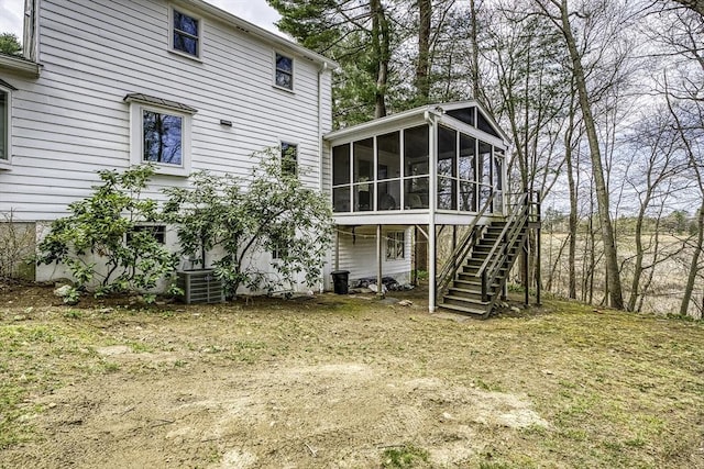 35 Wallace Rd, Wayland, MA 01778 - back of house featuring a sunroom, central AC, and stairway