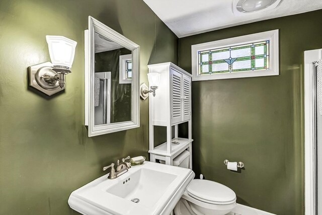 35 Wallace Rd, Wayland, MA 01778 - bathroom featuring a sink, baseboards, toilet, and a wealth of natural light
