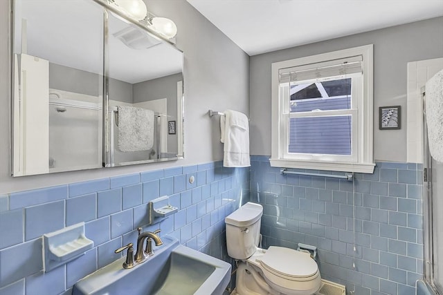 35 Wallace Rd, Wayland, MA 01778 - bathroom featuring toilet, a shower with door, tile walls, and a sink