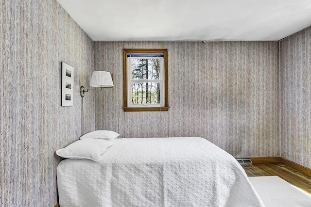 35 Wallace Rd, Wayland, MA 01778 - bedroom featuring visible vents, baseboards, wood finished floors, and wallpapered walls