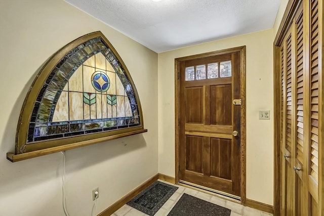35 Wallace Rd, Wayland, MA 01778 - entryway featuring a textured ceiling, baseboards, and light tile patterned floors