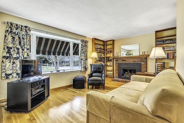 35 Wallace Rd, Wayland, MA 01778 - living room featuring baseboards, a brick fireplace, and wood finished floors