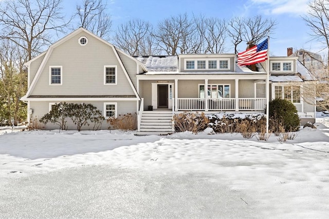 view of front of home featuring covered porch and a gambrel roof