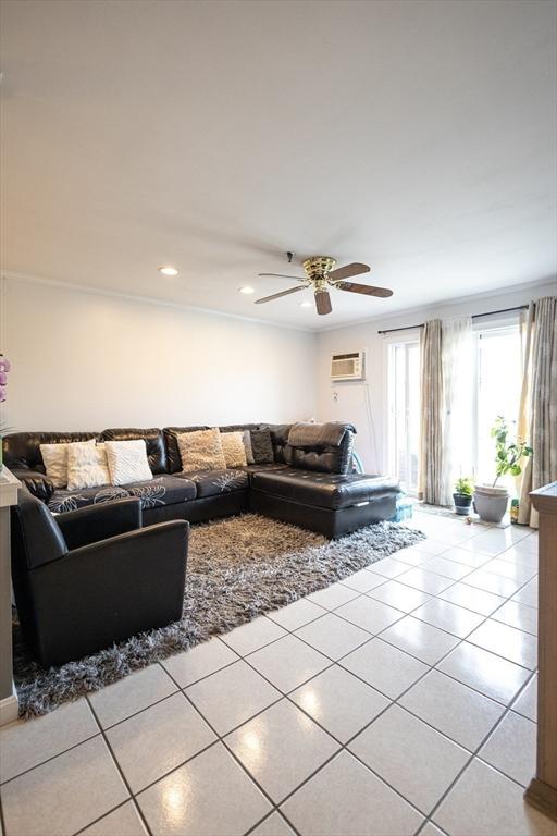 38 Carter St Unit 303, Everett, MA 02149 - living area featuring light tile patterned flooring, a ceiling fan, a wall mounted AC, and recessed lighting