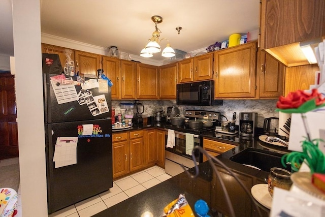 38 Carter St Unit 303, Everett, MA 02149 - kitchen featuring black appliances, light tile patterned floors, brown cabinetry, ornamental molding, and dark countertops