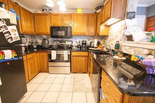38 Carter St Unit 303, Everett, MA 02149 - kitchen with black microwave, stainless steel electric stove, freestanding refrigerator, ornamental molding, and dark countertops