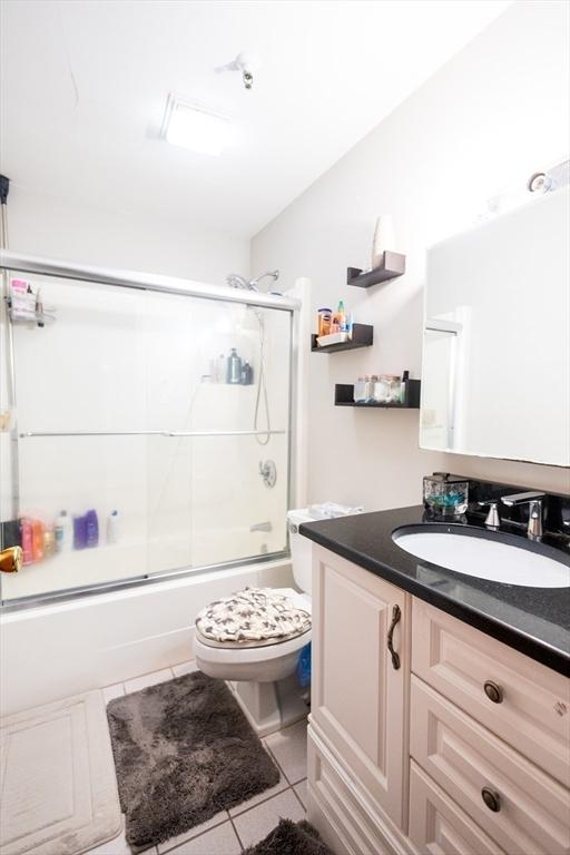 38 Carter St Unit 303, Everett, MA 02149 - full bathroom featuring tile patterned flooring, vanity, and bath / shower combo with glass door