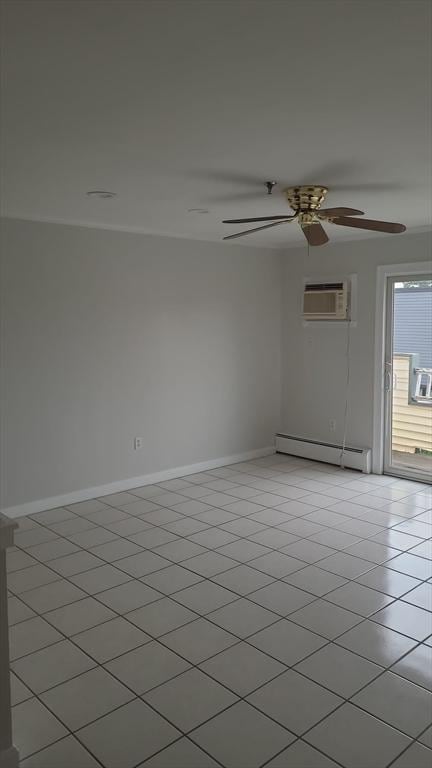 38 Carter St Unit 303, Everett, MA 02149 - empty room with baseboard heating, a wall mounted air conditioner, a ceiling fan, light tile patterned flooring, and cooling unit