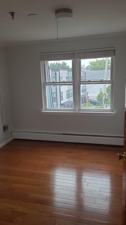 38 Carter St Unit 303, Everett, MA 02149 - spare room with a baseboard heating unit, wood finished floors, and fire sprinkler in ceiling