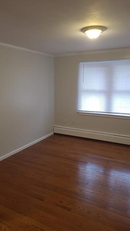38 Carter St Unit 303, Everett, MA 02149 - empty room featuring baseboard heating, crown molding, and dark wood-style floors