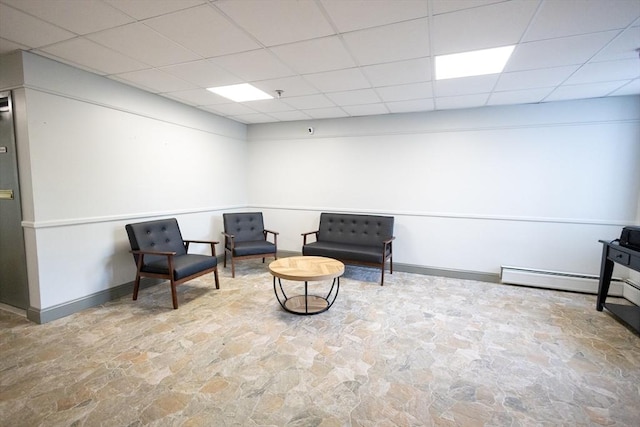 38 Carter St Unit 303, Everett, MA 02149 - sitting room featuring stone flooring, a drop ceiling, and a baseboard radiator