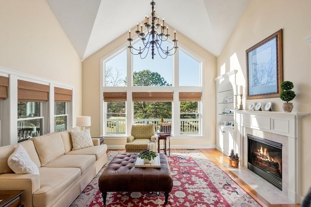 sunroom featuring vaulted ceiling, an inviting chandelier, and a wealth of natural light