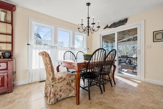 dining area featuring light tile patterned floors, a wealth of natural light, and a notable chandelier