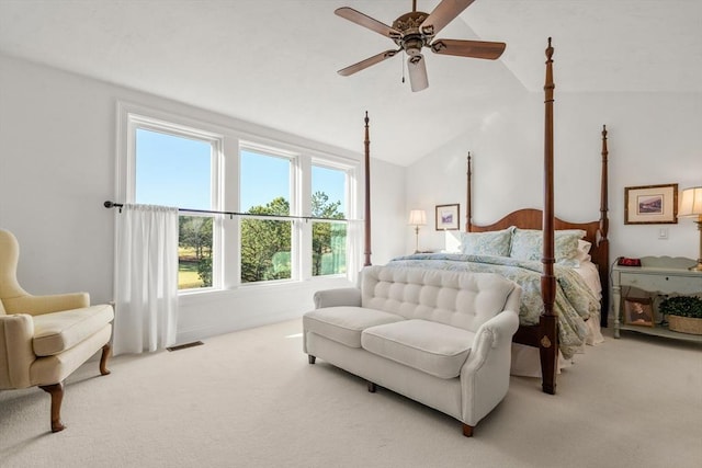 bedroom featuring ceiling fan, light colored carpet, and vaulted ceiling