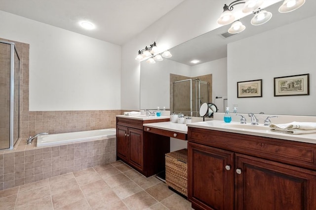 bathroom with plus walk in shower, vanity, and tile patterned flooring