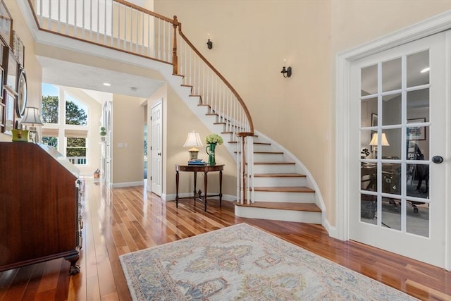 entrance foyer with a high ceiling and hardwood / wood-style flooring