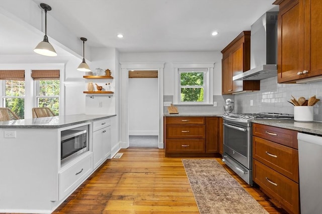 614 Summer St, Arlington, MA 02474 - kitchen with appliances with stainless steel finishes, wall chimney exhaust hood, light wood-style floors, plenty of natural light, and recessed lighting