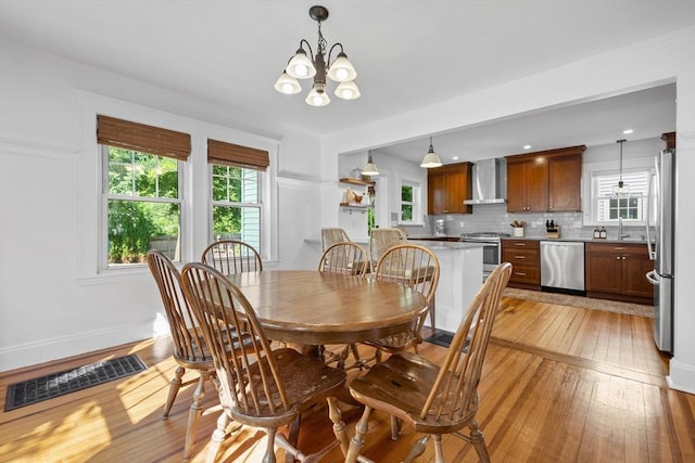 614 Summer St, Arlington, MA 02474 - dining area with light wood-style floors and a chandelier