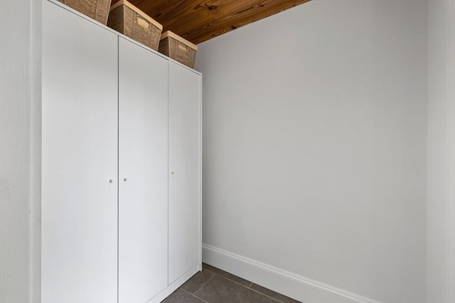 614 Summer St, Arlington, MA 02474 - unfurnished bedroom featuring dark tile patterned floors, a closet, and wood ceiling
