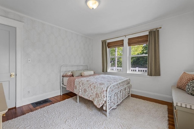 614 Summer St, Arlington, MA 02474 - bedroom with wallpapered walls, wood finished floors, and ornamental molding