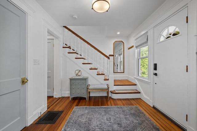 614 Summer St, Arlington, MA 02474 - foyer with wood finished floors, stairway, and recessed lighting
