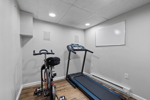 614 Summer St, Arlington, MA 02474 - workout room featuring wood finished floors, baseboard heating, recessed lighting, and a paneled ceiling