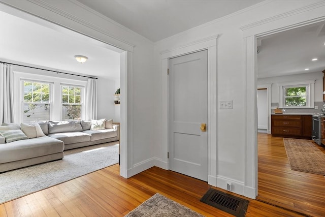 614 Summer St, Arlington, MA 02474 - living area with hardwood / wood-style flooring and crown molding