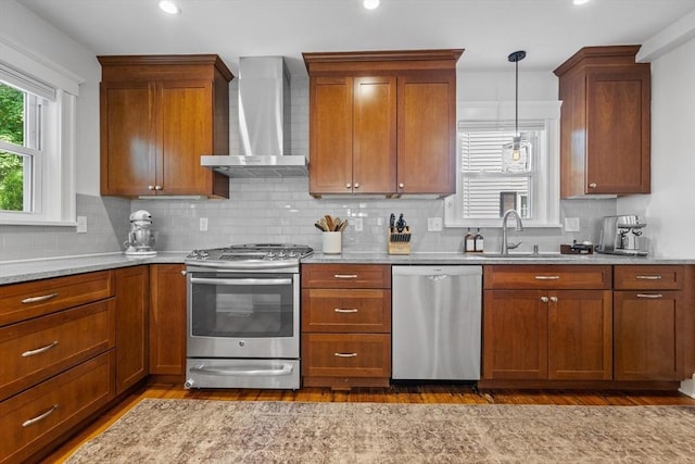 614 Summer St, Arlington, MA 02474 - kitchen featuring stainless steel appliances, wall chimney range hood, dark wood-type flooring, decorative backsplash, and recessed lighting